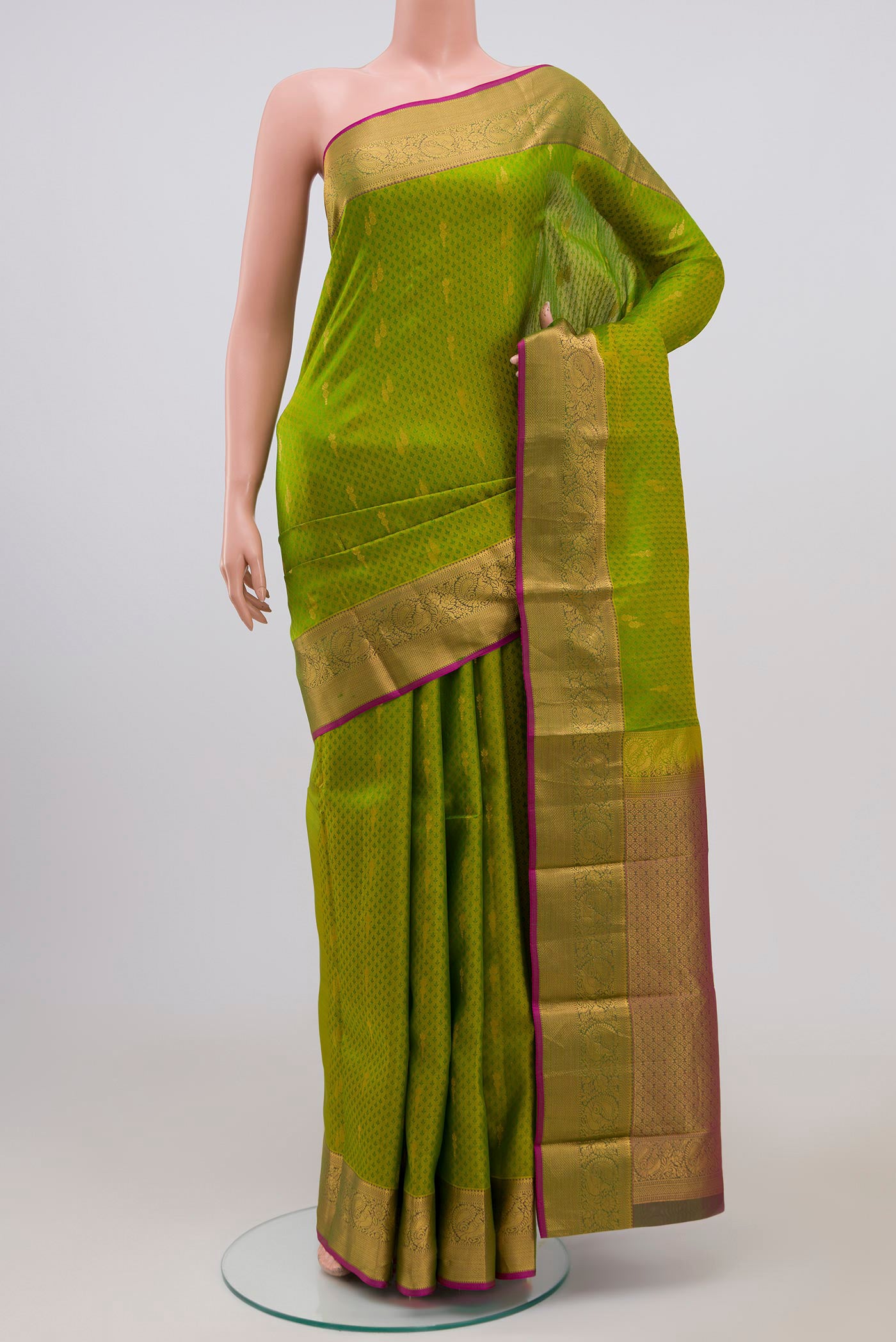 Green Kanchipuram Saree with Jacquard With Zari Butta on the body and Zari Border.  displayed on a mannequin