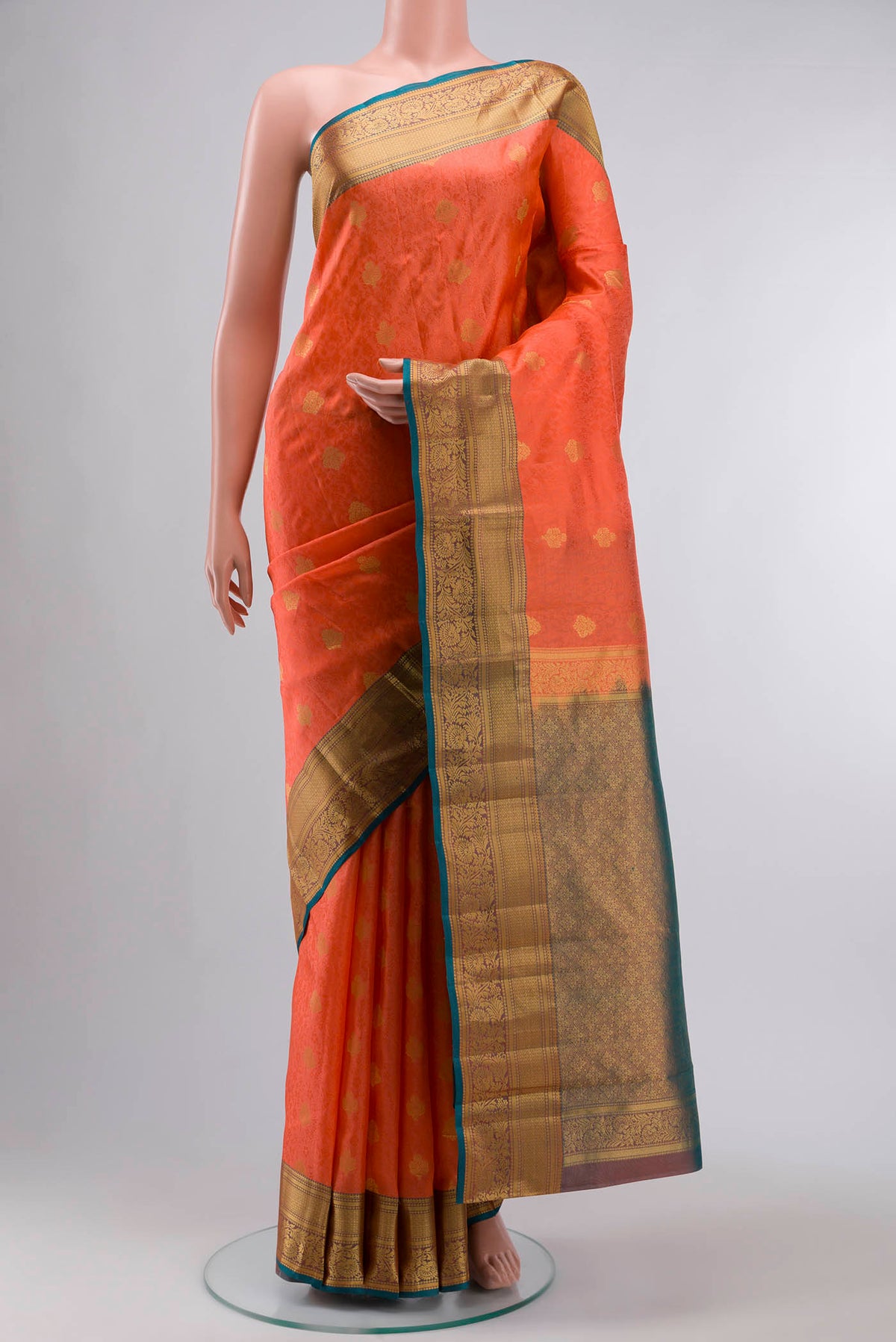 Coral Kanchipuram Silk Saree with Jacquard With Zari Butta on the body and Zari Border displayed on a mannequin
