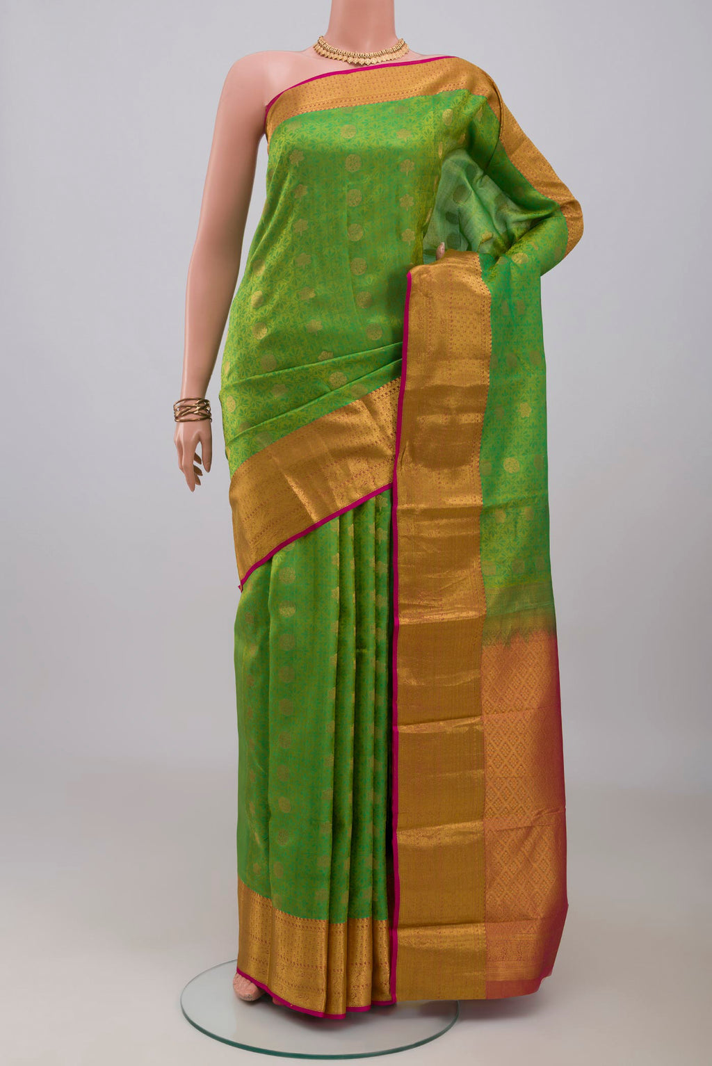 Green Kanchipuram Silk Saree with Jacquard With Zari Butta on the body and Zari Border.  displayed on a mannequin
