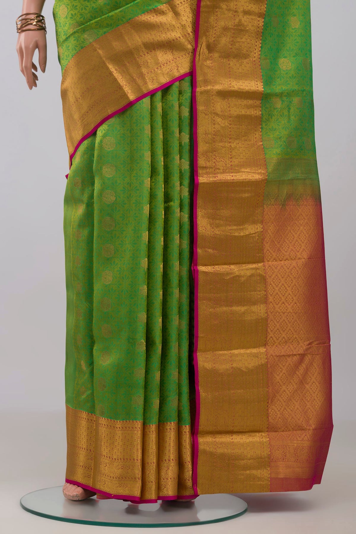 Pleats and pallu of Green Kanchipuram Silk Saree with Jacquard With Zari Butta on the body and Zari Border. 