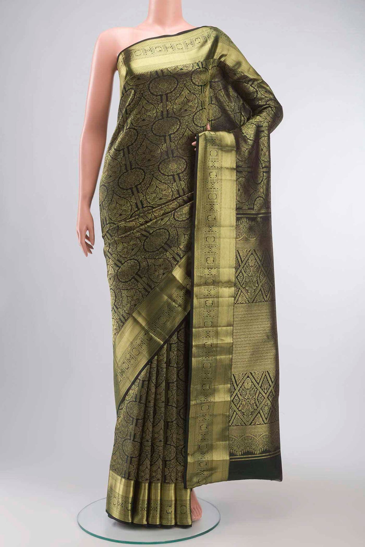 Bottle Green Kanchipuram Silk Saree with Zari Brocade on the body and Zari Border displayed on a mannequin