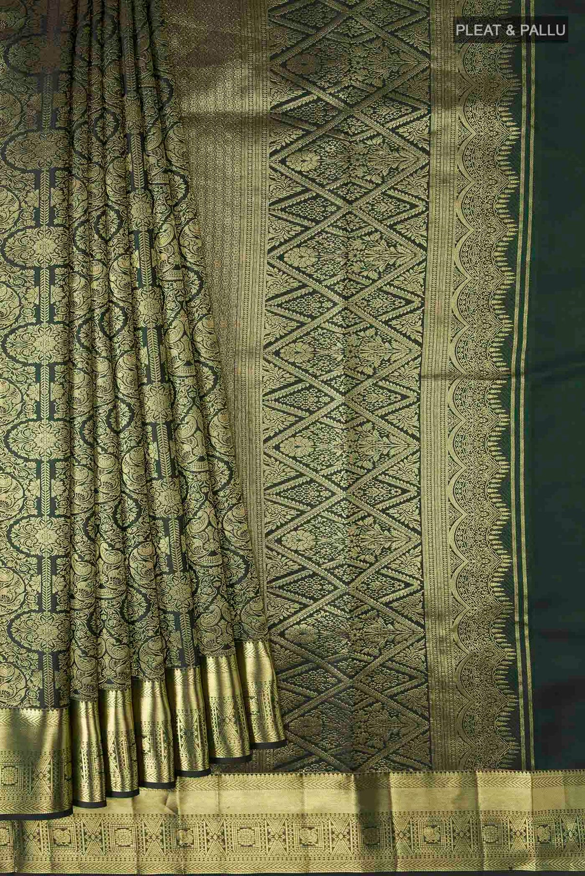 Pleats and pallu of Bottle Green Kanchipuram Silk Saree with Zari Brocade on the body and Zari Border