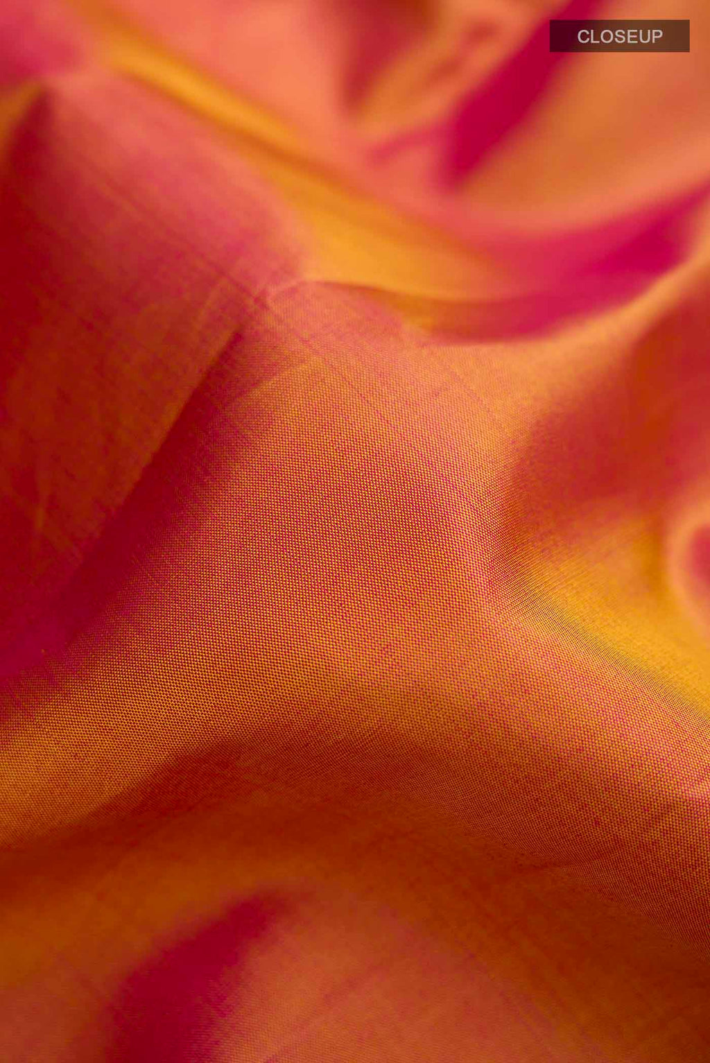 Close up of Mustard with Pink Color Kanchipuram Silk Saree with Plain Body and Zari Border displaying folds