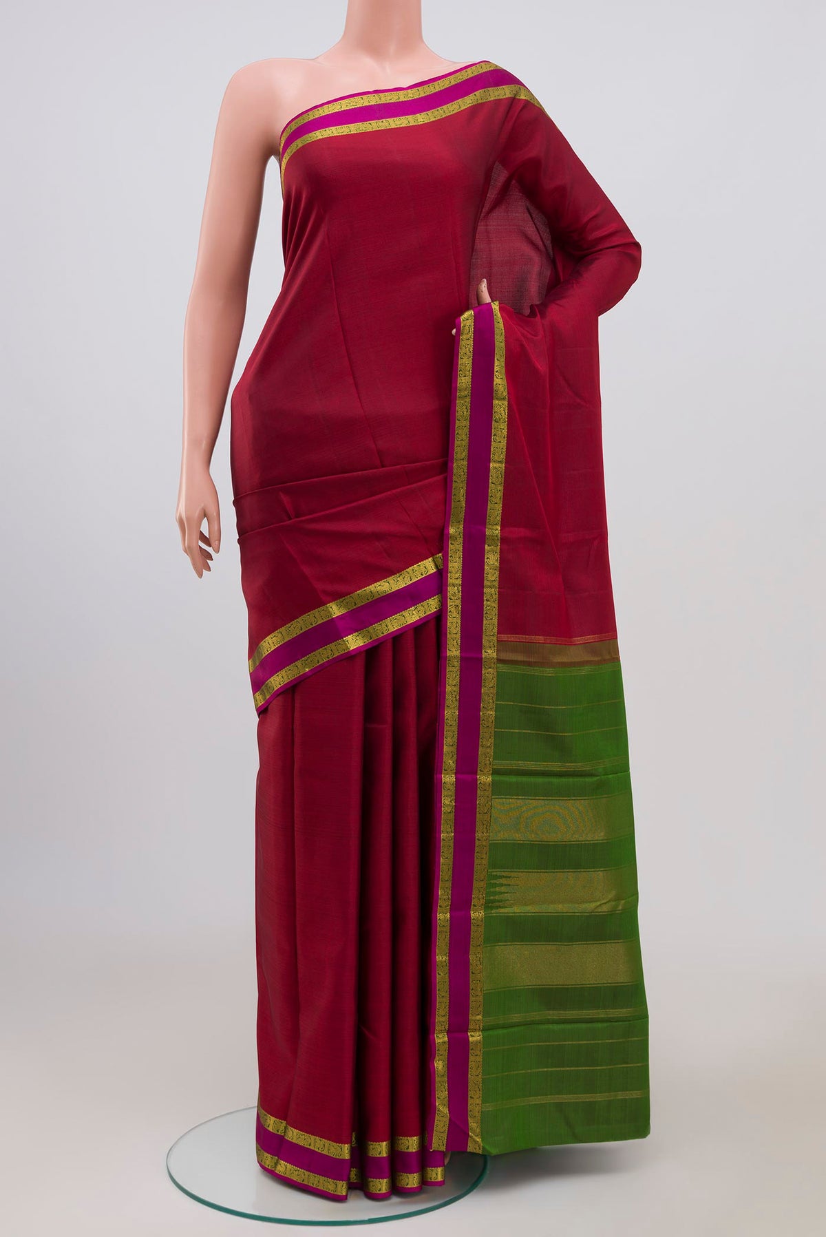 Pure Silk Pure Zari Maroon Kanchipuram Saree with Plain Body and Zari Border.  displayed on a mannequin