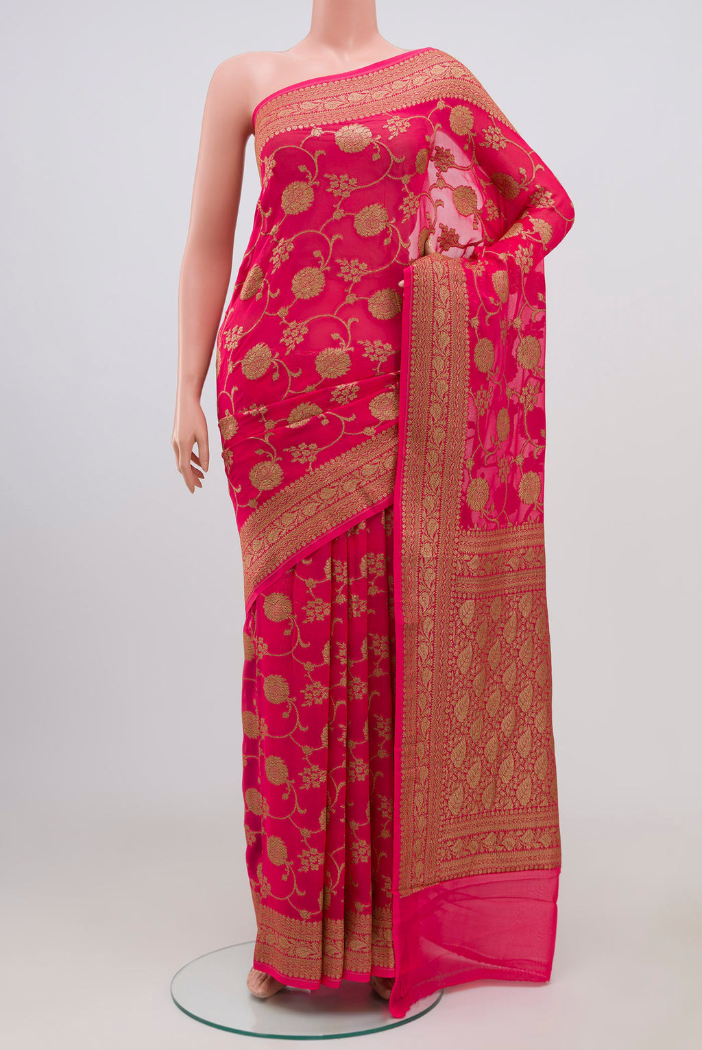Pink Banarasi Georgette Saree with Fancy on the body and Zari Border.  displayed on a mannequin