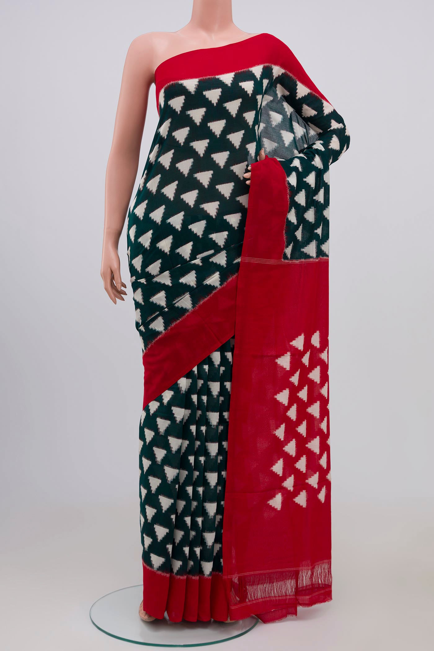 Green Pochampally Cotton Saree with Ikat design on the body and Plain Border.  displayed on a mannequin