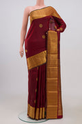 Pure Silk Pure Zari Maroon Kanchipuram Saree with Zari Butta on the body and Zari Border.  displayed on a mannequin
