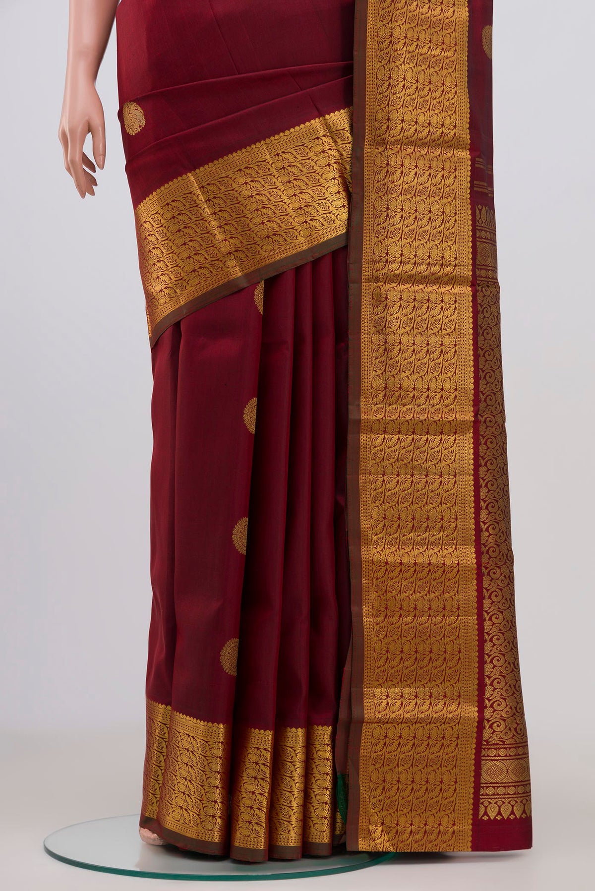 Pleats and pallu of Pure Silk Pure Zari Maroon Kanchipuram Saree with Zari Butta on the body and Zari Border. 