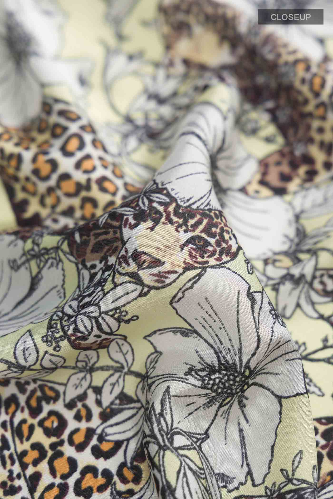 Close up of Green Mysore Crepe Saree with Printed design on the body and Zari Border displaying folds