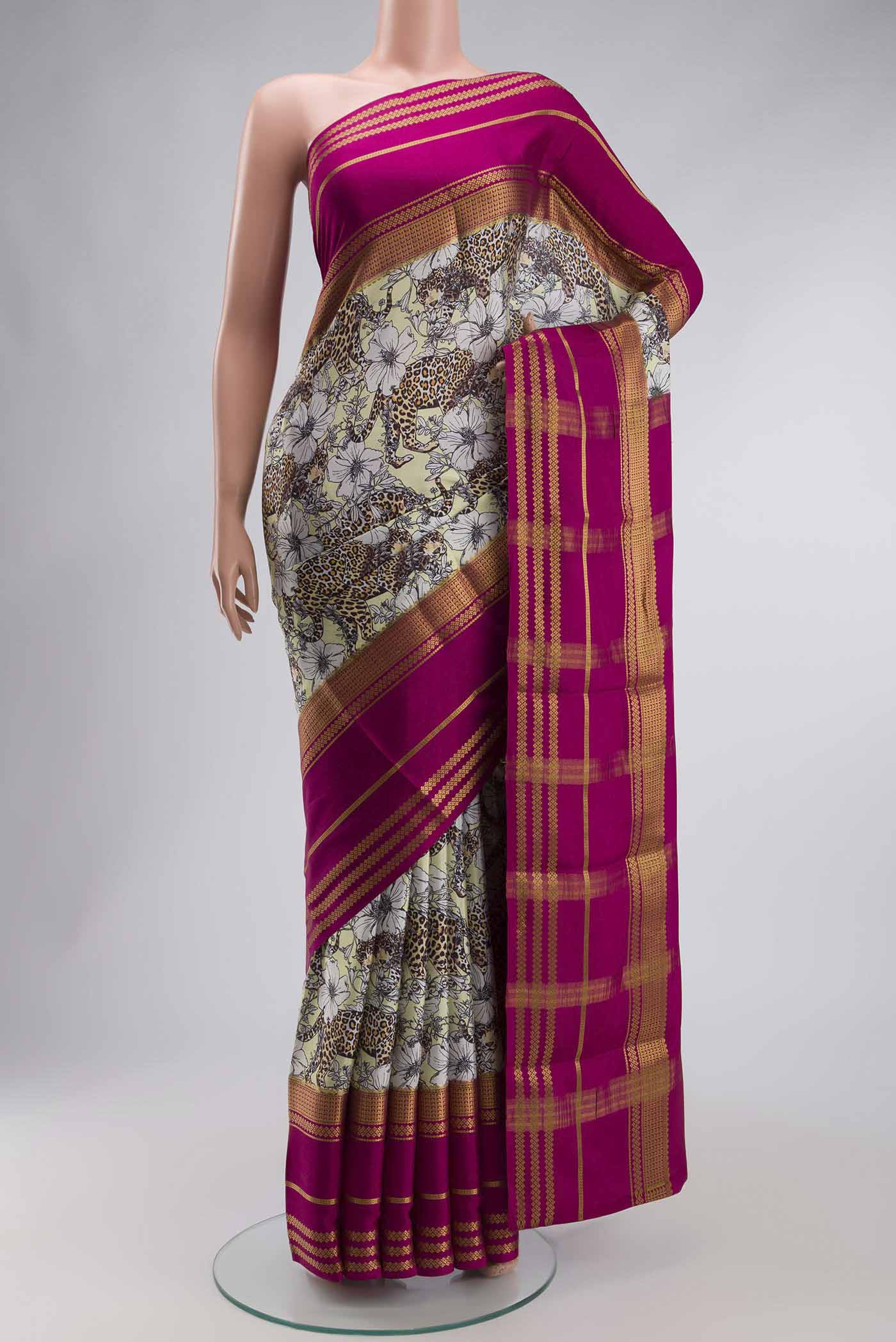 Green Mysore Crepe Saree with Printed design on the body and Zari Border displayed on a mannequin