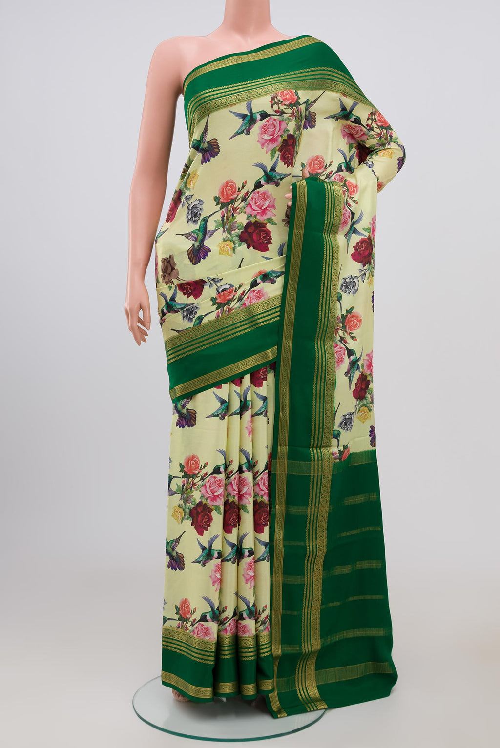 Light Green Crepe Saree with Printed design on the body and Zari Border.  displayed on a mannequin