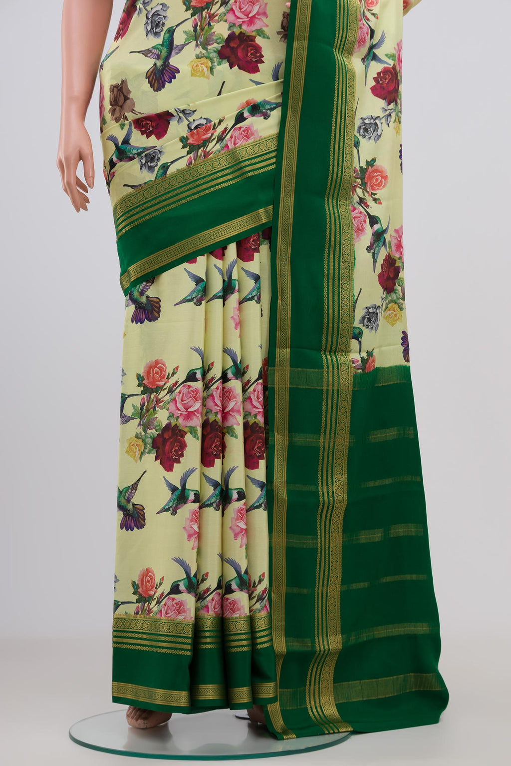 Pleats and pallu of Light Green Crepe Saree with Printed design on the body and Zari Border. 