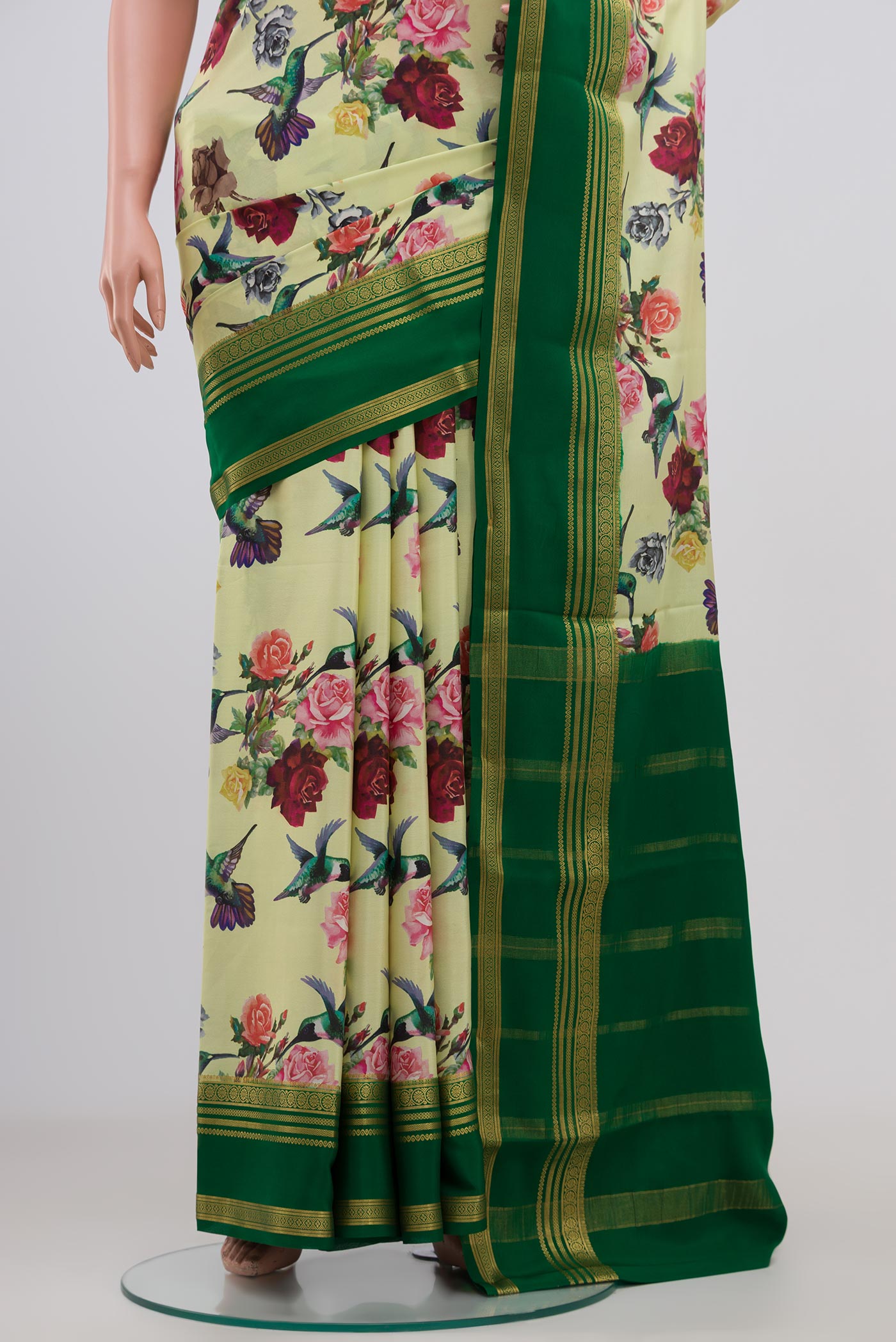 Pleats and pallu of Light Green Crepe Saree with Printed design on the body and Zari Border. 