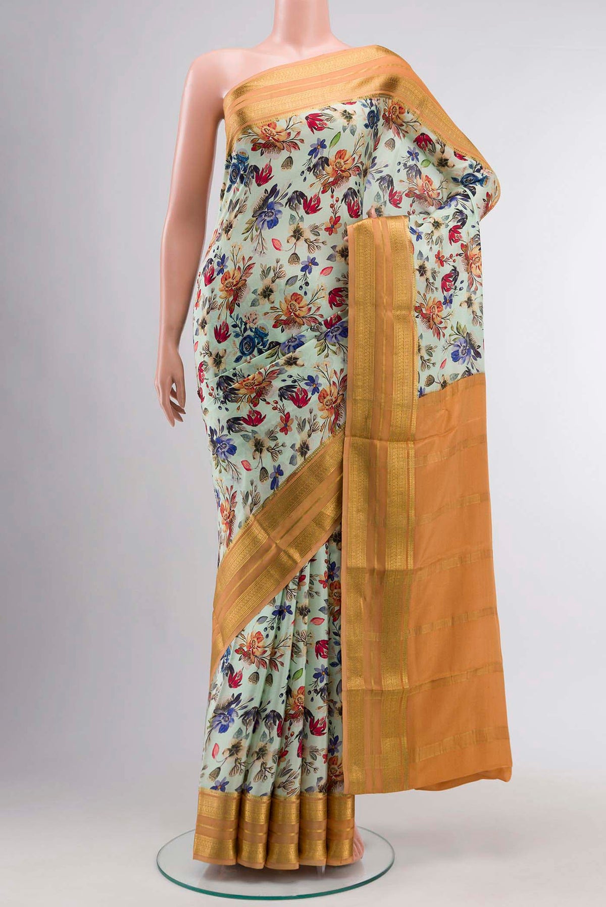 Green Mysore Crepe Saree with Printed design on the body and Zari Border displayed on a mannequin