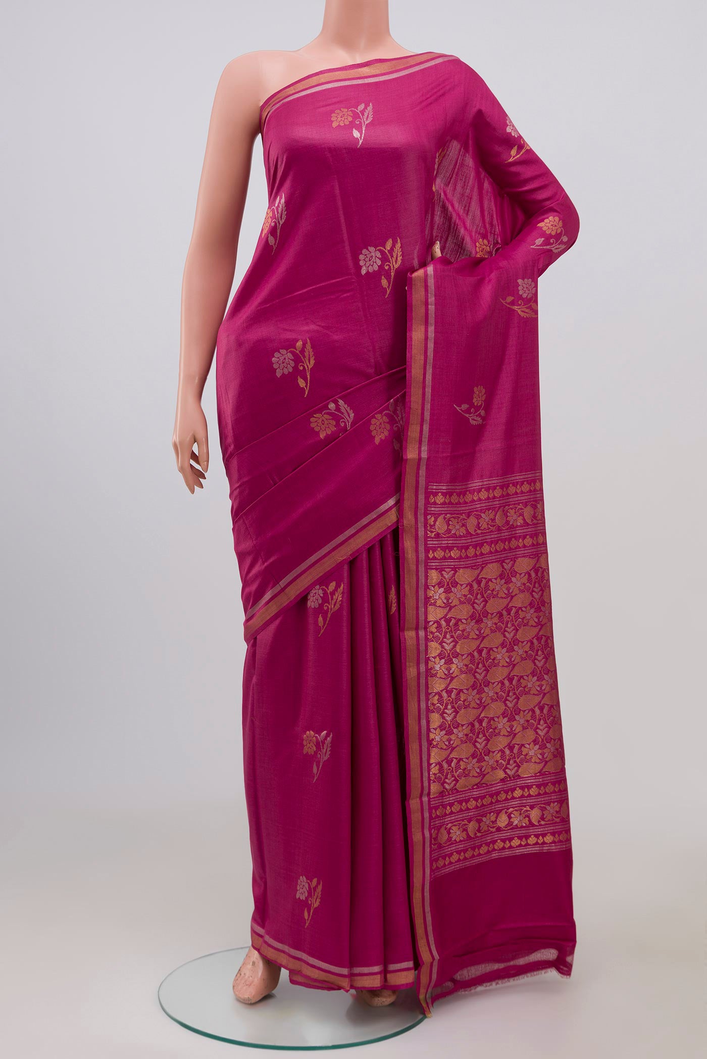Pink Tussar Saree with Zari Butta on the body and Thin Zari Line.  displayed on a mannequin