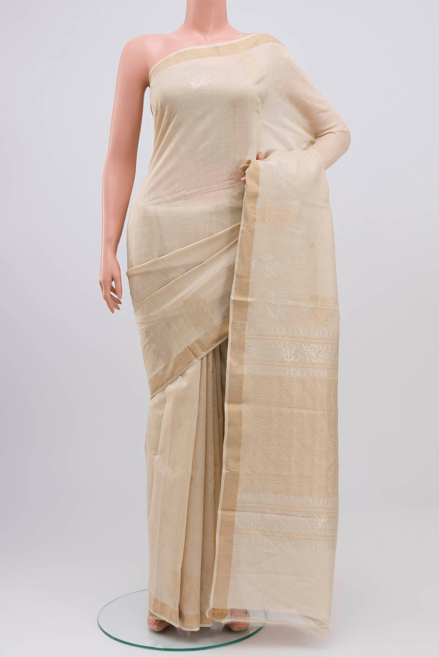 Cream Tussar Silk Saree with Zari Butta on the body and Zari Border displayed on a mannequin