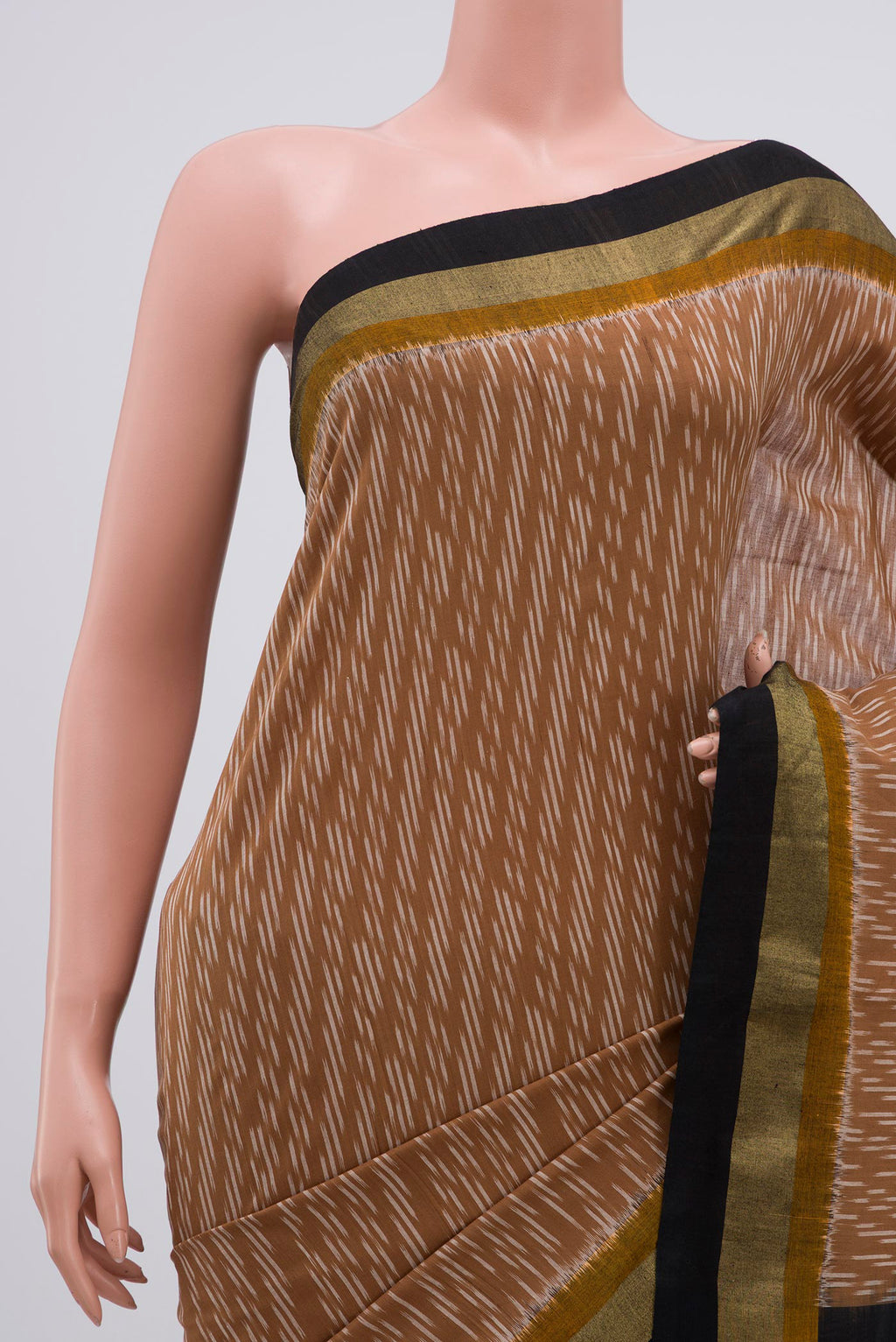 Border image of Brown Pochampally Cotton Saree with Ikat design on the body and Zari Border. 