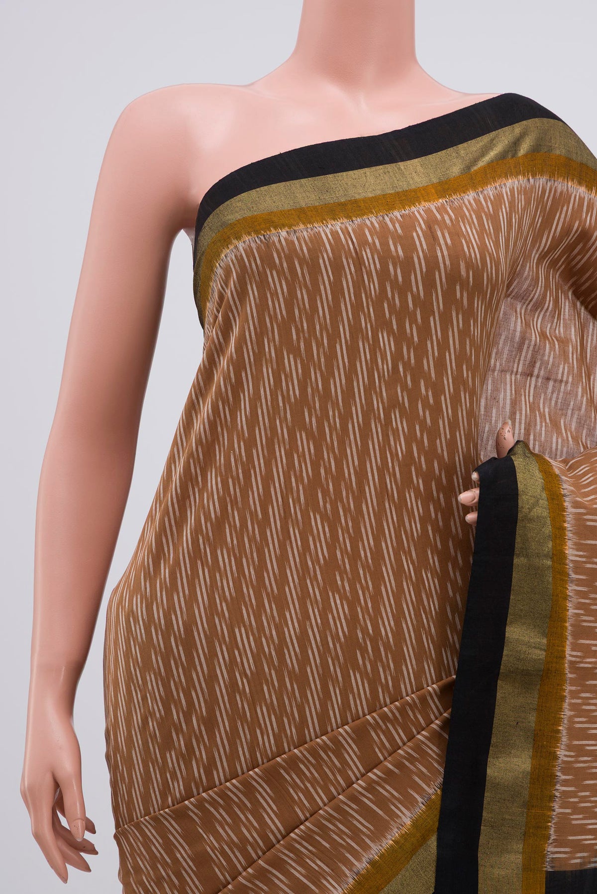 Border image of Brown Pochampally Cotton Saree with Ikat design on the body and Zari Border. 