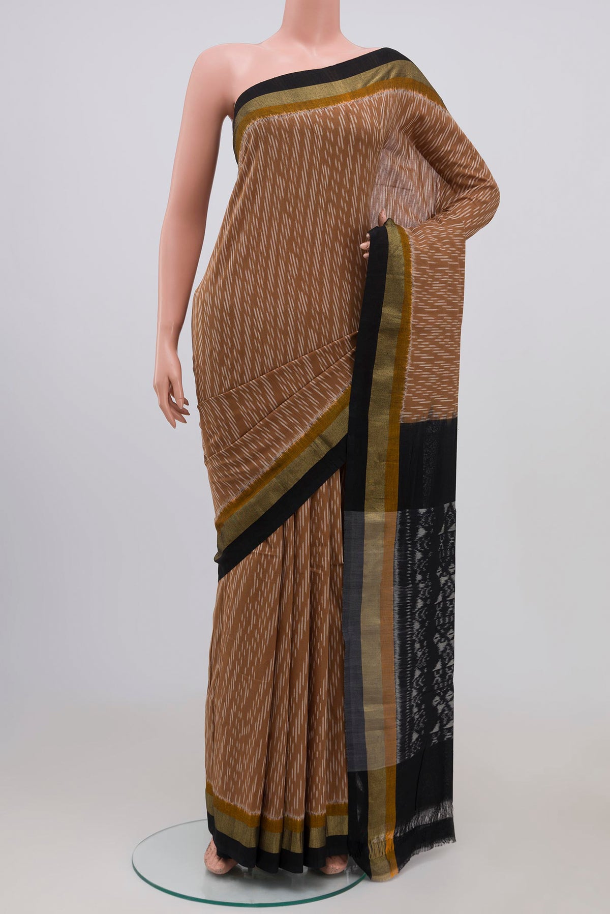 Brown Pochampally Cotton Saree with Ikat design on the body and Zari Border.  displayed on a mannequin