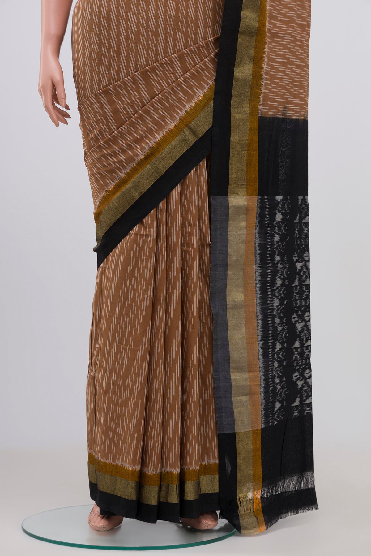Pleats and pallu of Brown Pochampally Cotton Saree with Ikat design on the body and Zari Border. 