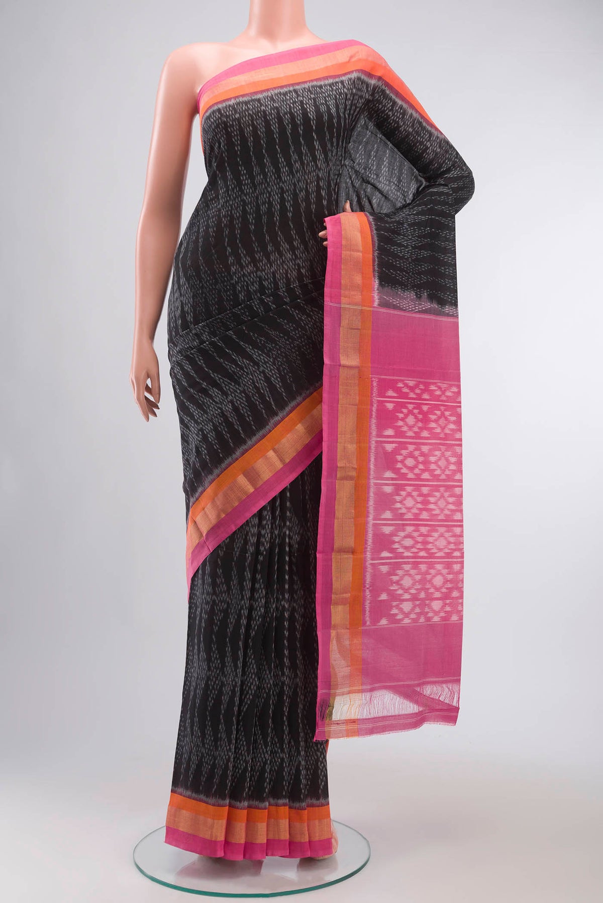 Black Pochampally Cotton Saree with Pure Ikat on the body and Zari Border displayed on a mannequin