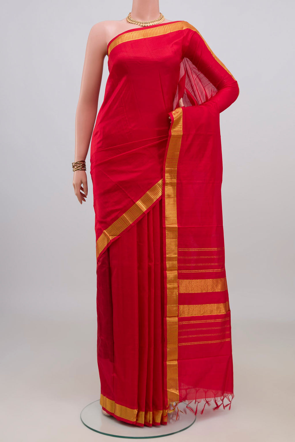 Pure Silk Red Kanjivaram Saree with Plain Body and Zari Border.  displayed on a mannequin