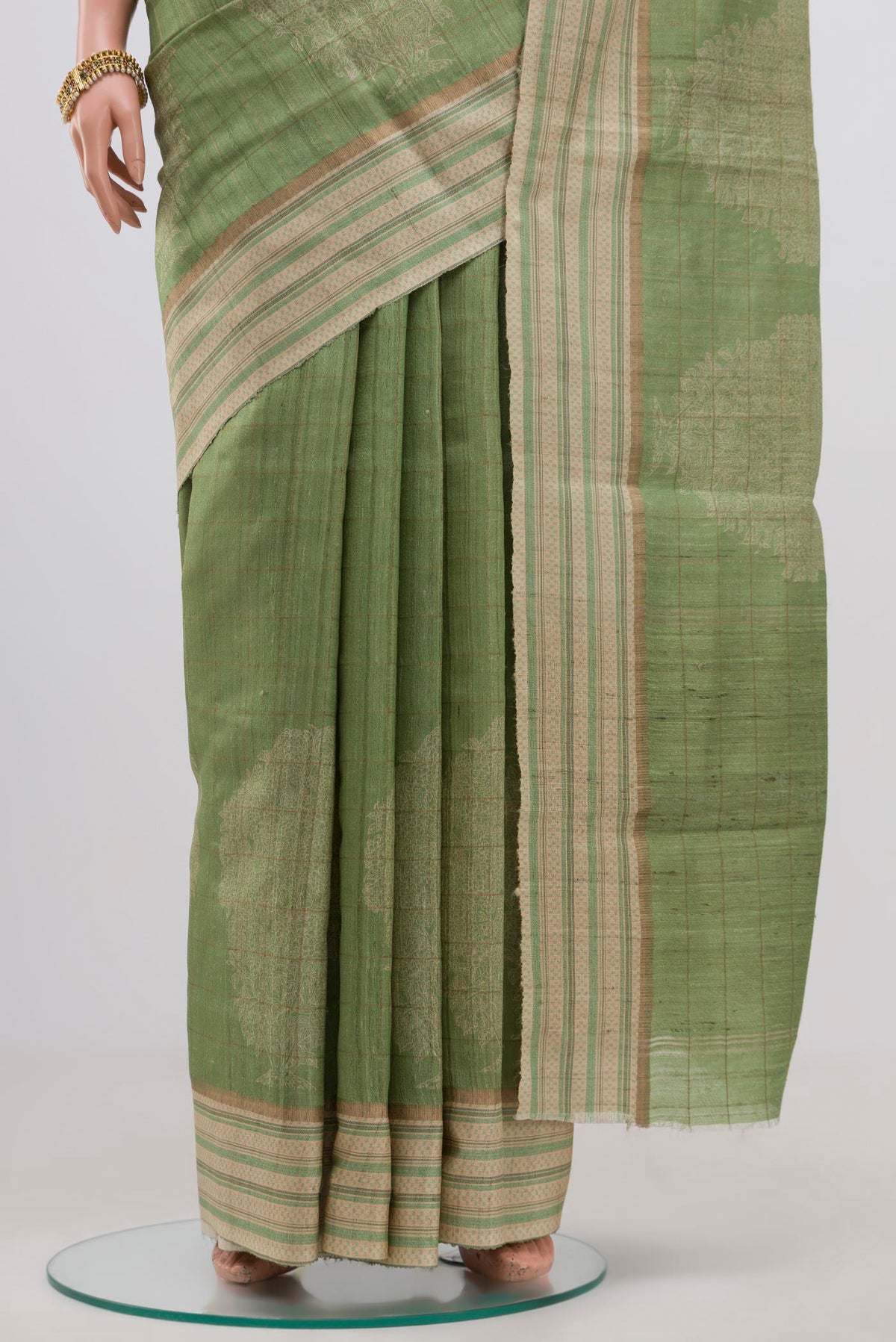 Pleats and pallu of Green Tussar Silk Saree with Fancy on the body and Thin Zari Line. 