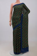 Green Printed Silk Saree with Printed design on the body and Plain Border.  displayed on a mannequin