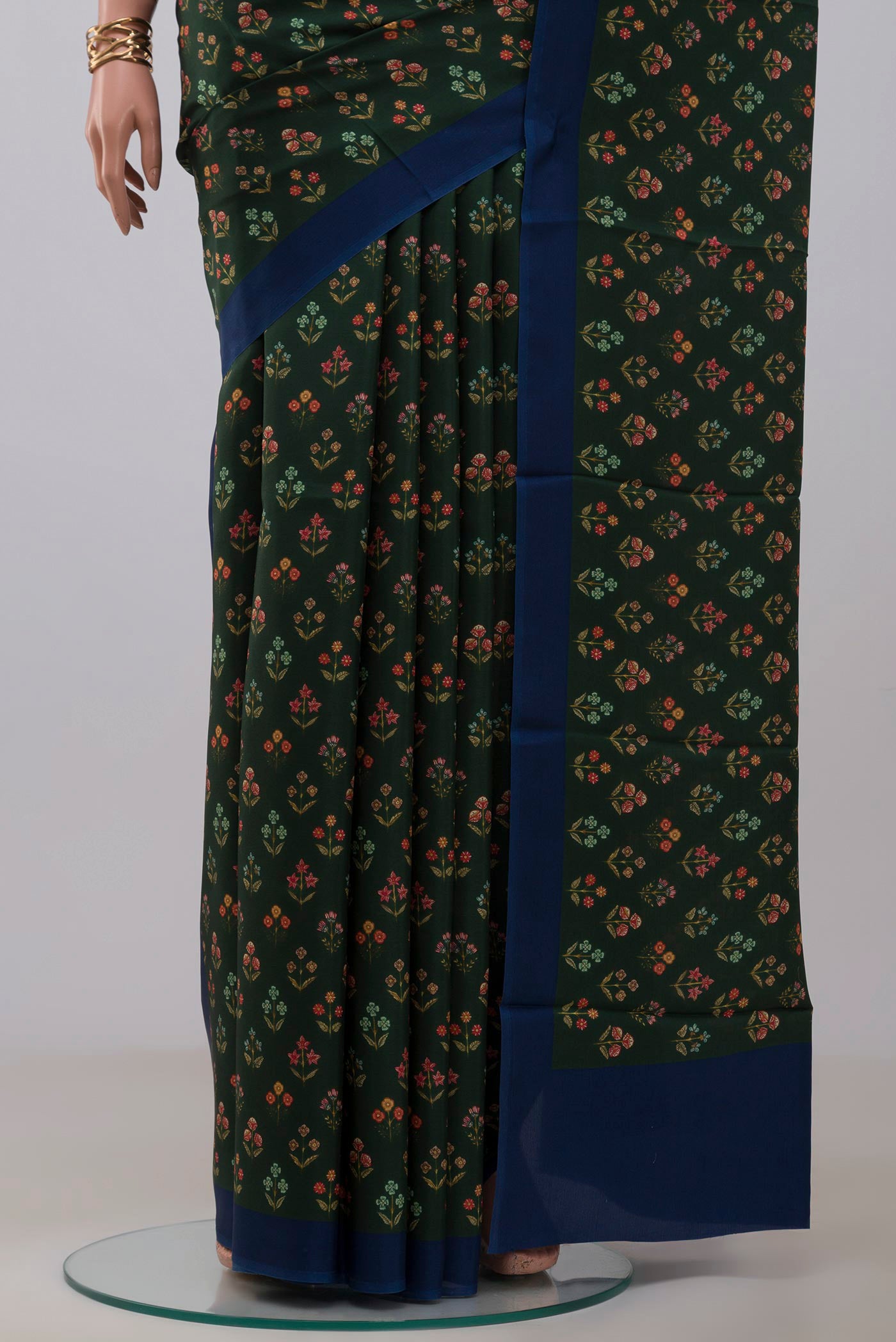 Pleats and pallu of Green Printed Silk Saree with Printed design on the body and Plain Border. 