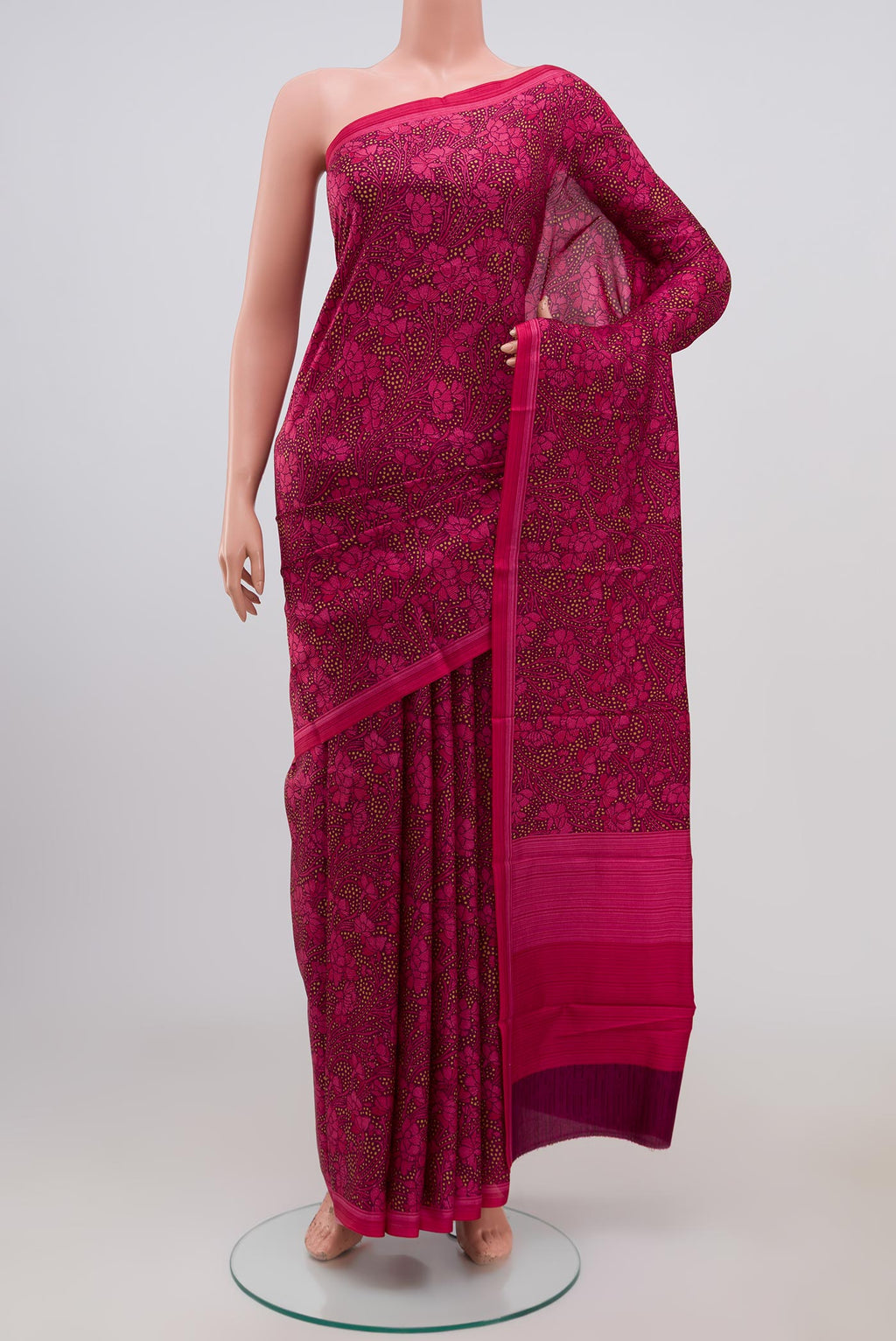 Brown Printed Silk Saree with Printed design on the body and Plain Border.  displayed on a mannequin