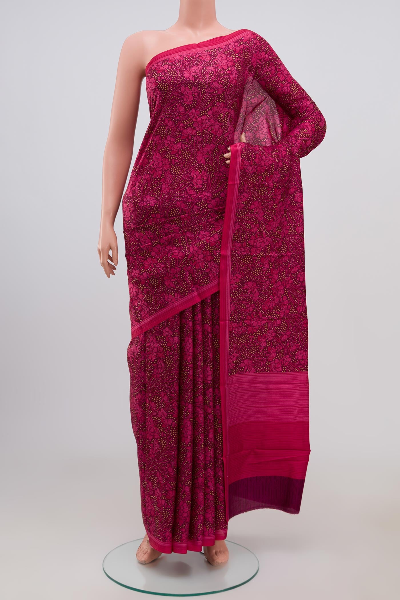 Brown Printed Silk Saree with Printed design on the body and Plain Border.  displayed on a mannequin