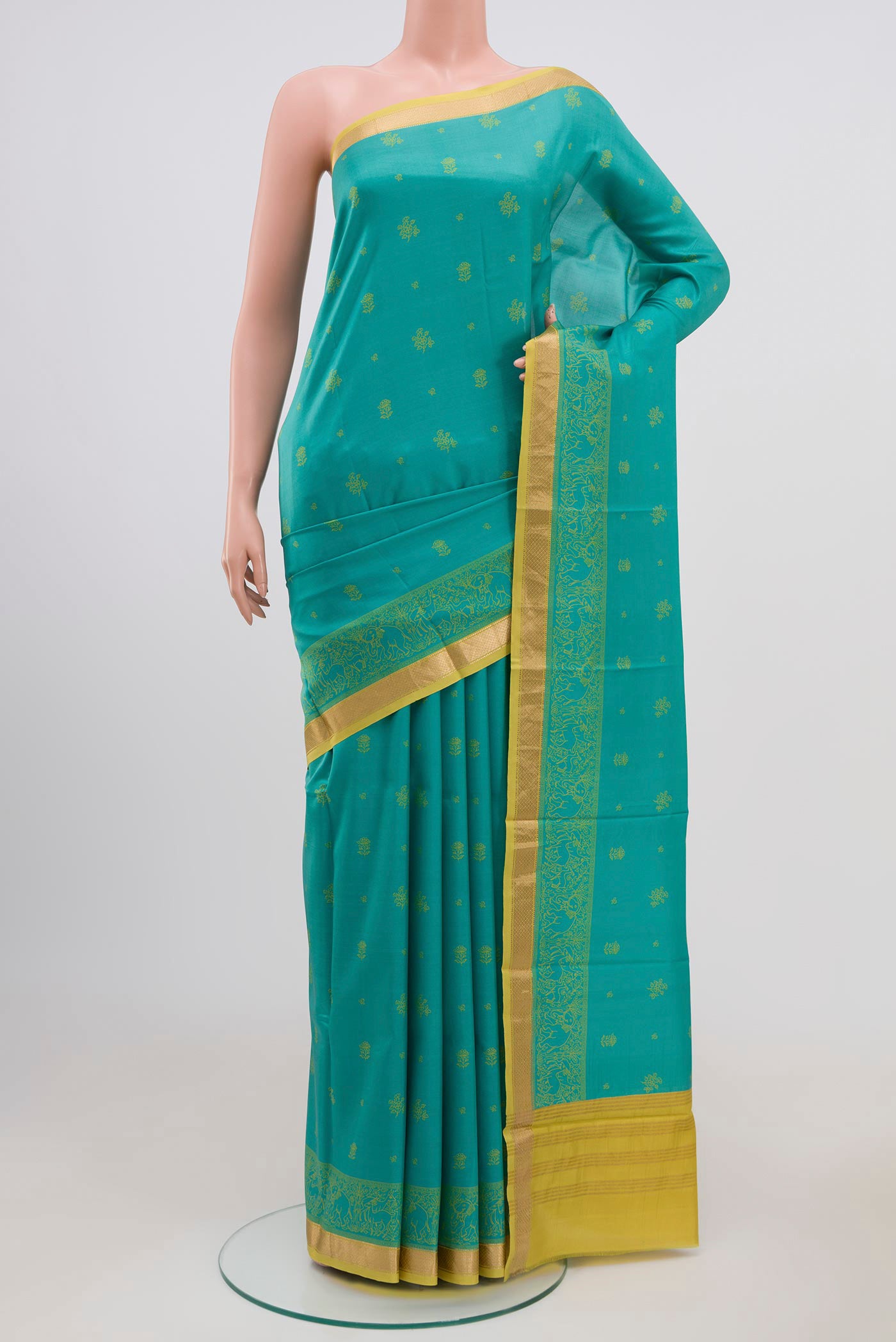 Blue Printed Silk Saree with Printed design on the body and Zari Border.  displayed on a mannequin