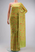 Green Printed Silk Saree with Floral Print on the body and Zari Border displayed on a mannequin