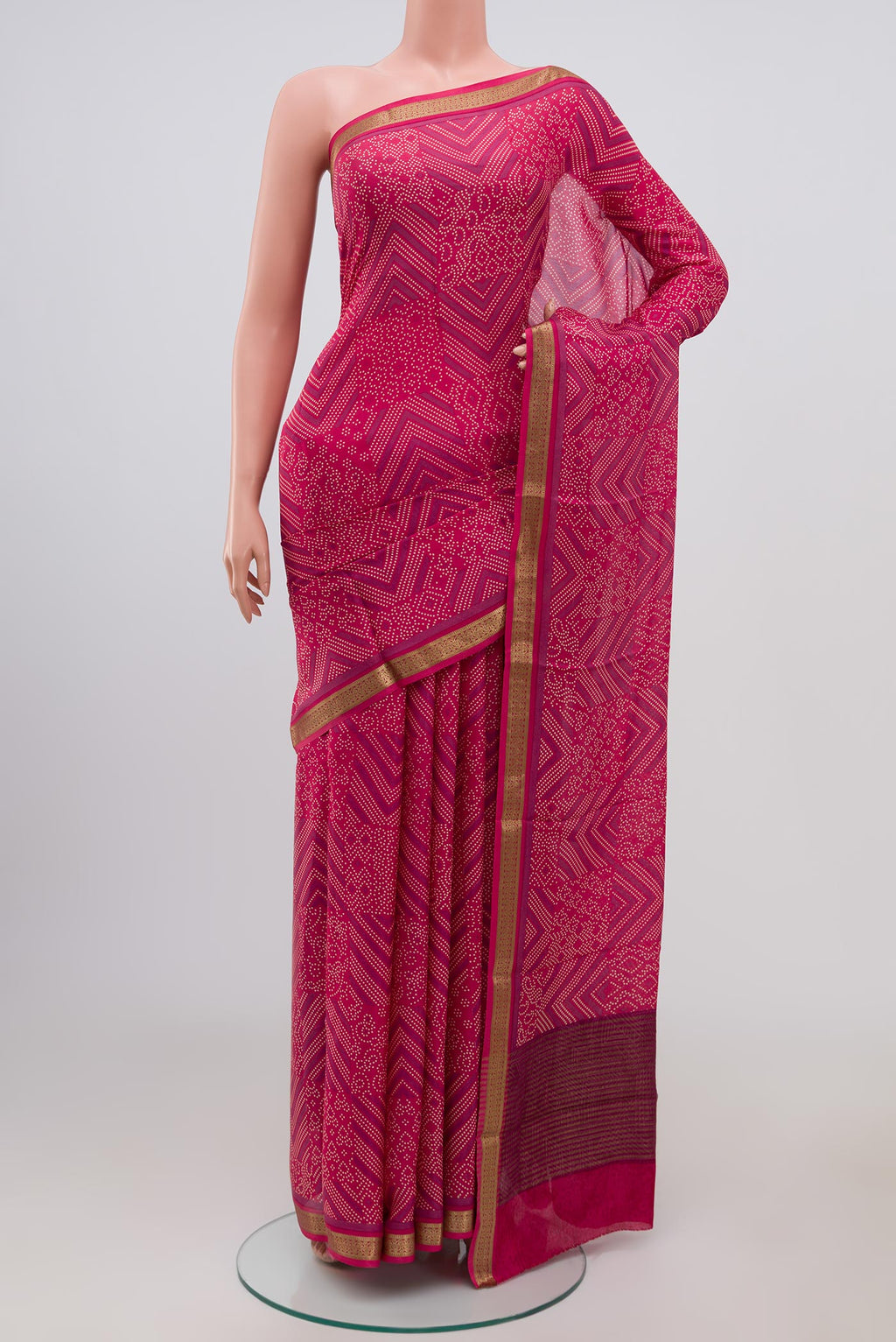 Pink Crepe Saree with Printed design on the body and Zari Border.  displayed on a mannequin