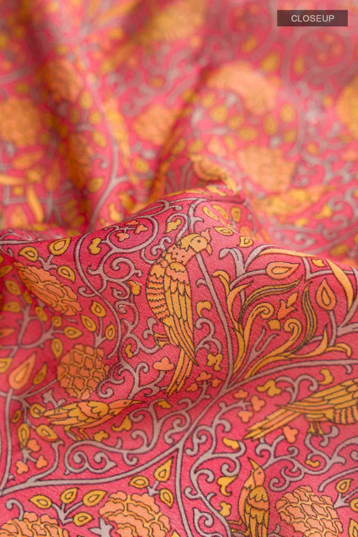 Close up of Pink Mysore Crepe Saree with Printed design on the body and Zari Border displaying folds