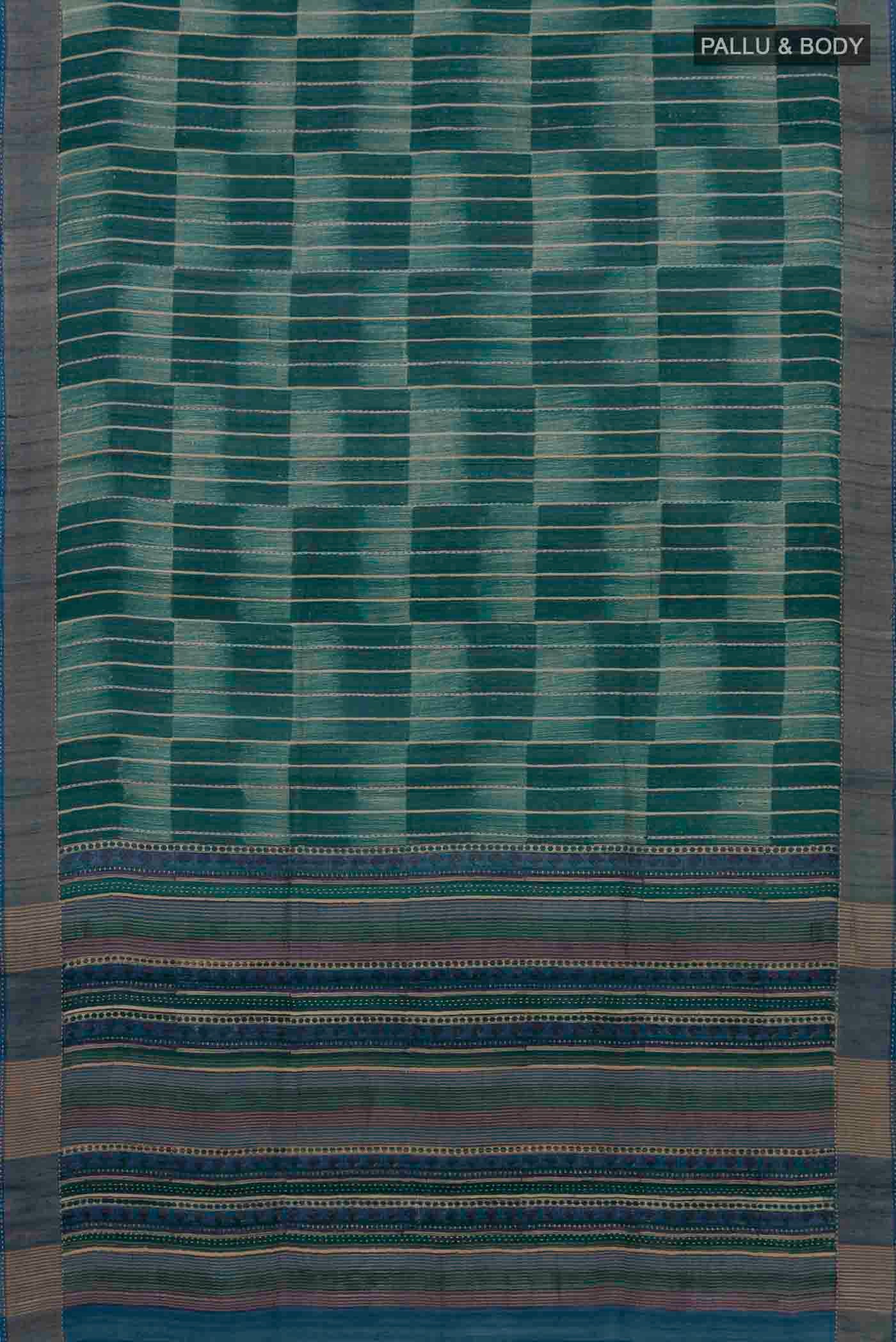 Flat view of Green Tussar Silk Saree with Printed design on the body and Zari Border. 