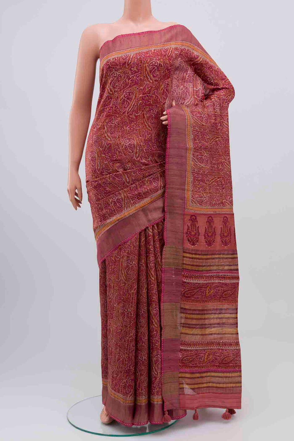 Mauve Tussar Silk Saree with Printed design on the body and Zari Border displayed on a mannequin