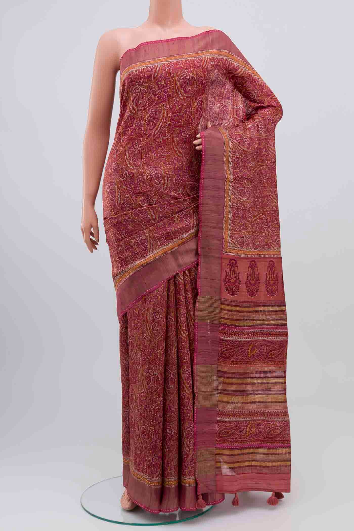 Mauve Tussar Silk Saree with Printed design on the body and Zari Border displayed on a mannequin