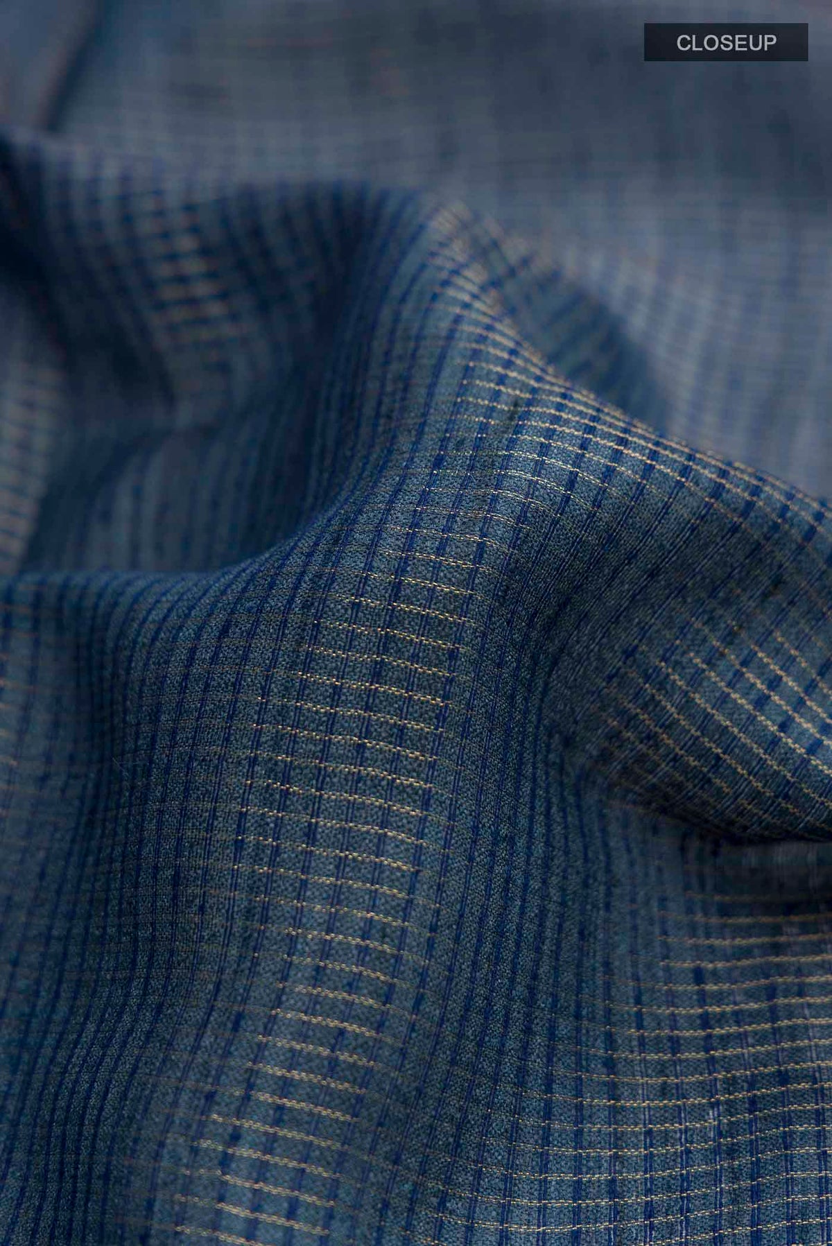 Close up of Blue Bhagalpuri Tussar Silk Saree with Checked design on the body and Zari Border displaying folds