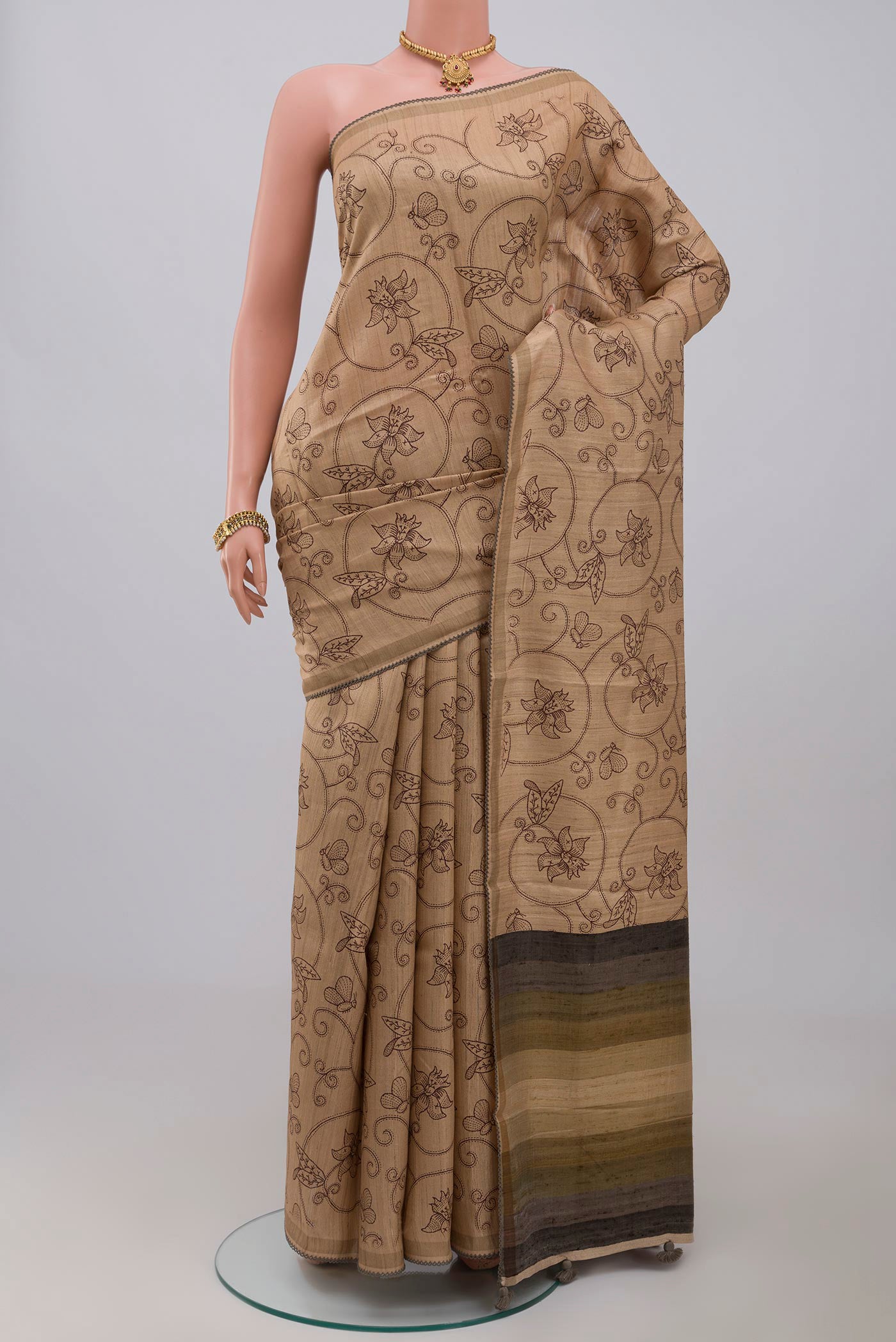 Cream Tussar Silk Saree with Fancy on the body and Plain Border.  displayed on a mannequin
