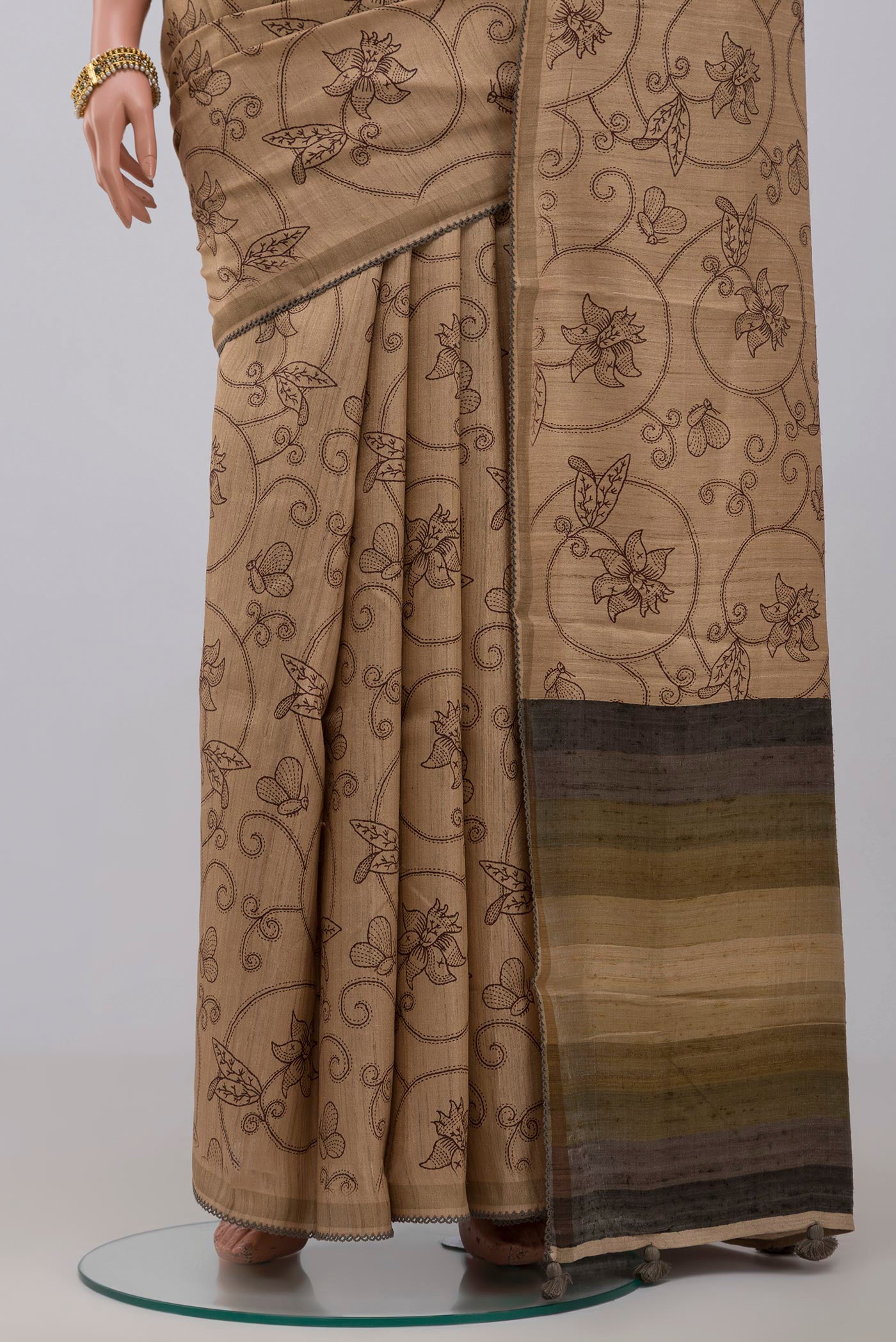 Pleats and pallu of Cream Tussar Silk Saree with Fancy on the body and Plain Border. 