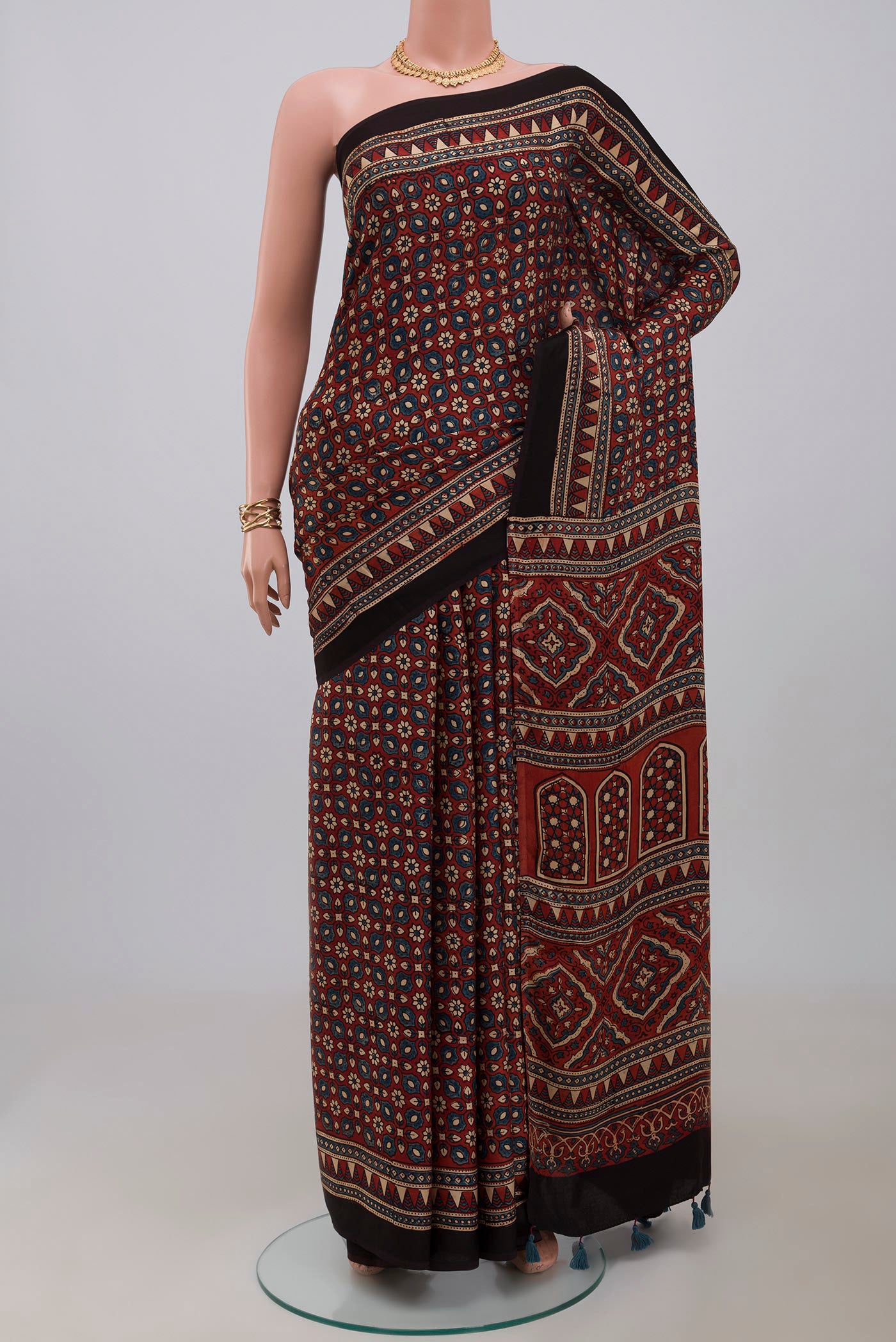 Maroon Blended Satin Silk Saree with Ajrakh Print on the body and Printed Border.  displayed on a mannequin