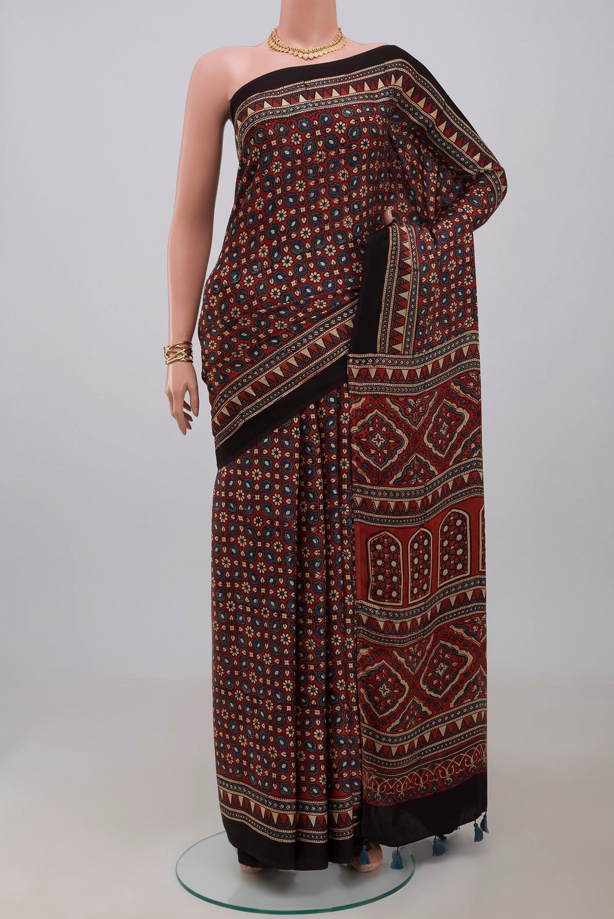 Maroon Blended Satin Silk Saree with Ajrakh Print on the body and Printed Border.  displayed on a mannequin