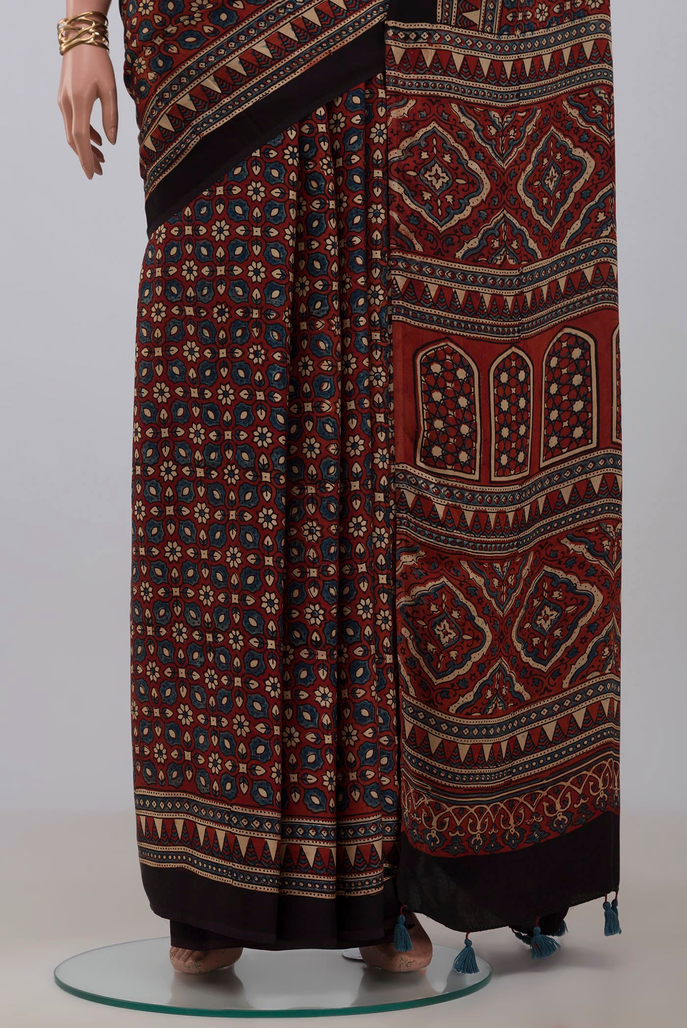 Pleats and pallu of Maroon Blended Satin Silk Saree with Ajrakh Print on the body and Printed Border. 