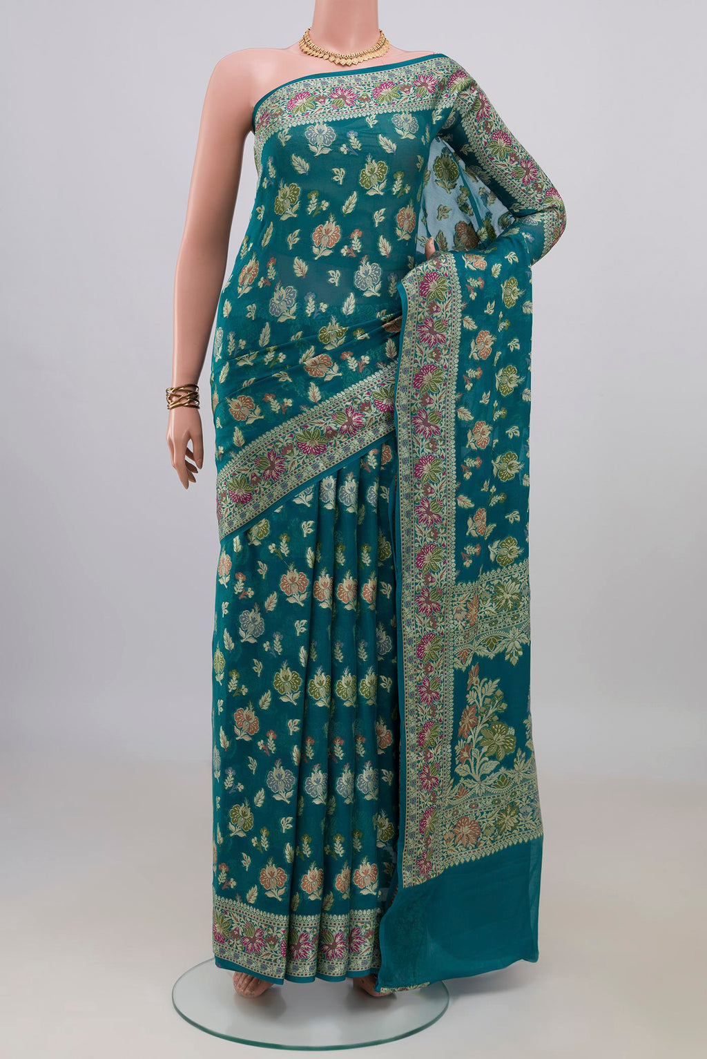 Teal Banarasi Georgette Saree with Thread Butta on the body and Zari Border.  displayed on a mannequin