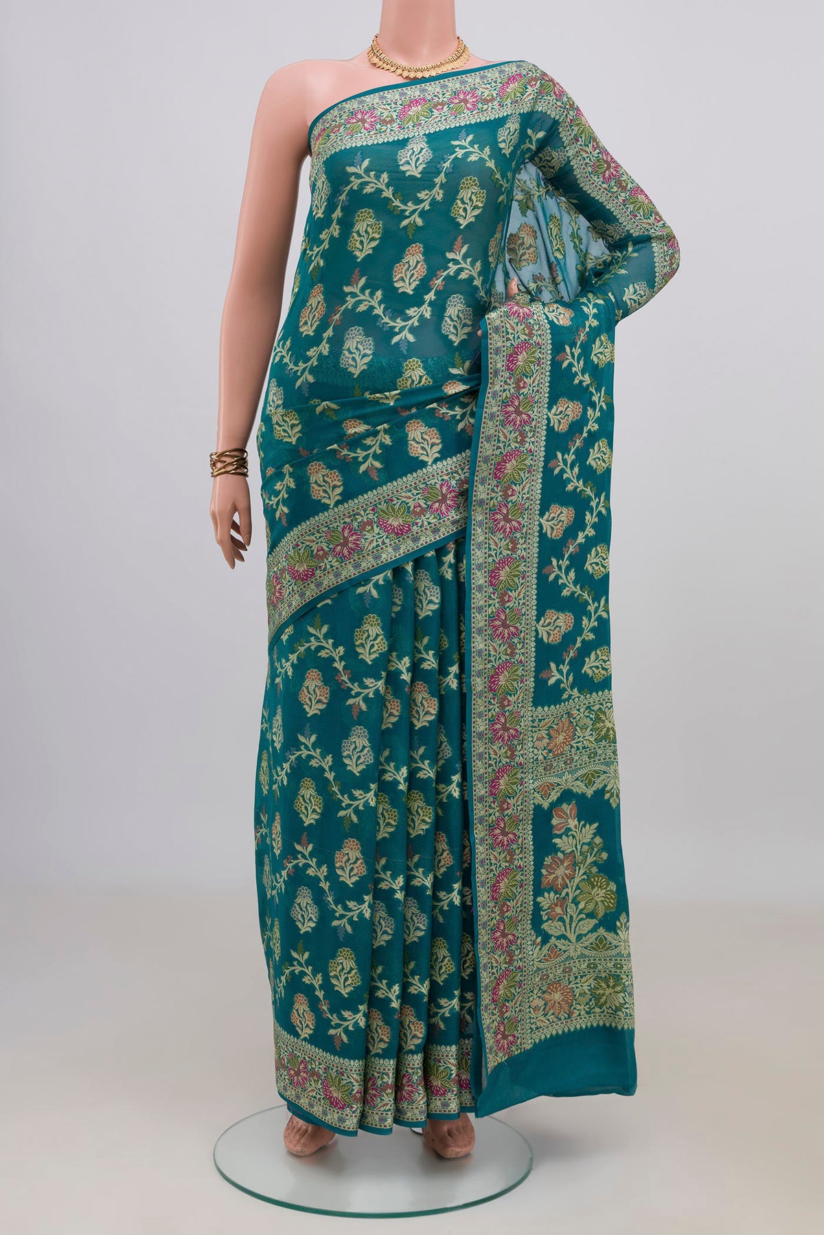 Teal Banarasi Georgette Saree with Thread Butta on the body and Zari Border.  displayed on a mannequin