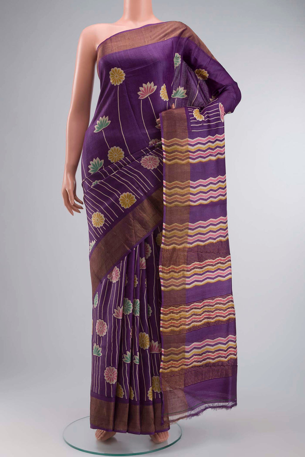 Violet Tussar Silk Saree with Printed design on the body and Zari Border displayed on a mannequin