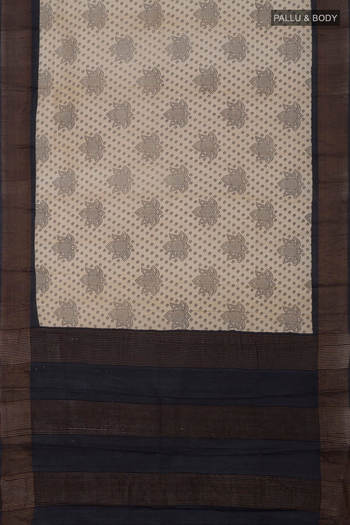 Flat view of Cream Tussar Silk Saree with Printed design on the body and Zari Border. 