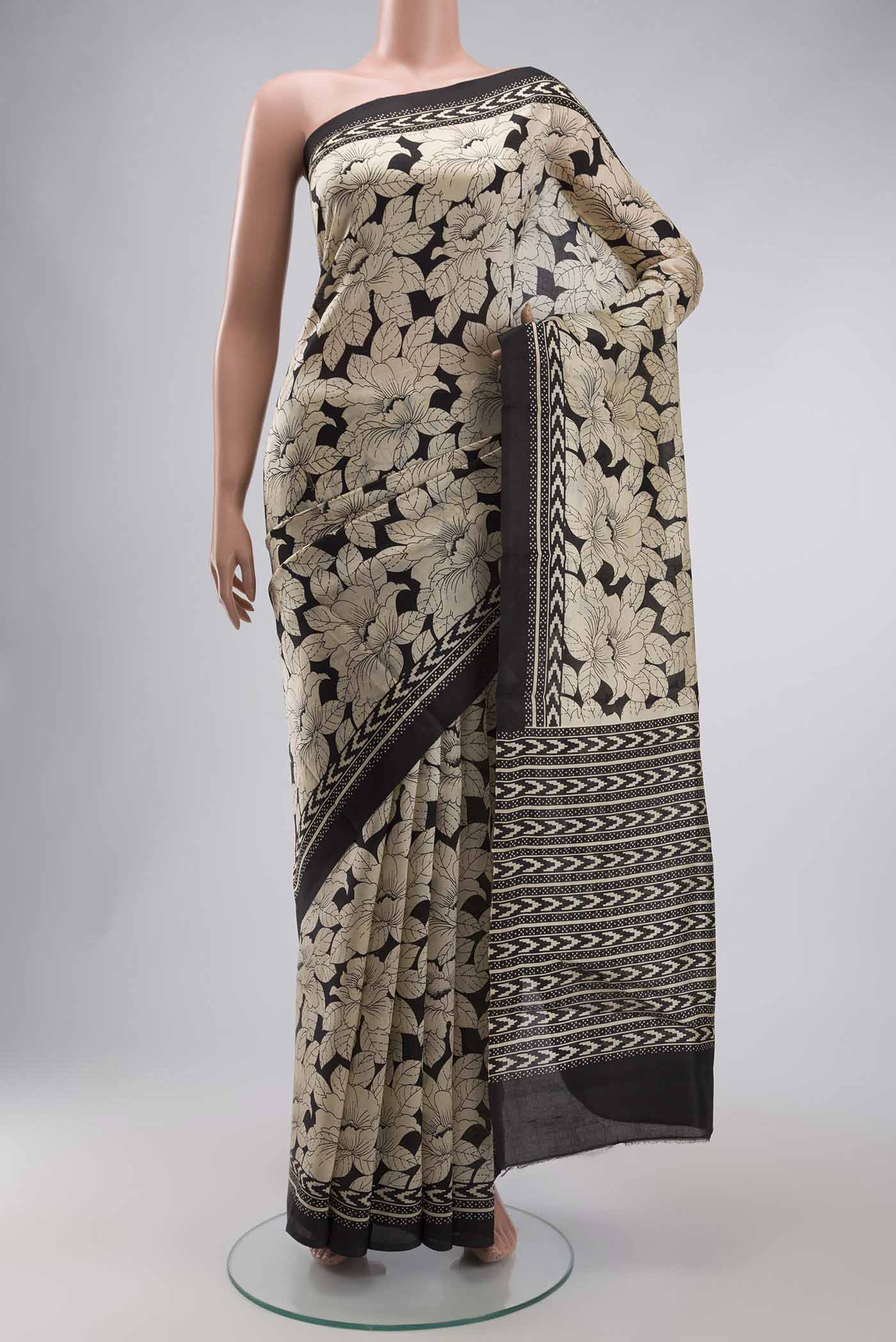 Cream Printed Silk Saree with Printed design on the body and Plain Border displayed on a mannequin