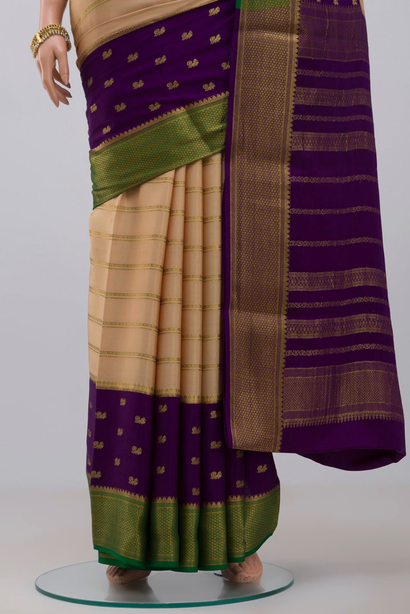 Pleats and pallu of Cream Crepe Saree with Stripes on the body and Zari Border. 